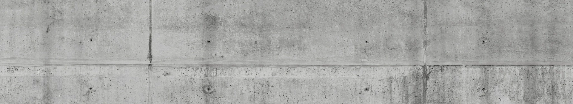 ściana pokryta szarym betonem